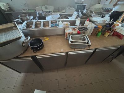 a picture of a kitchen with a lot of clutter on the counter