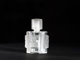 a close up of a bottle of perfume on a black surface