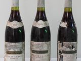 three bottles of wine are lined up on a white surface