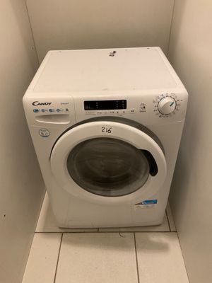 a white washer and dryer in a small room