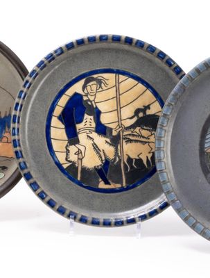 three plates with different designs on them on a white surface