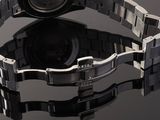 a close up of a watch on a black surface