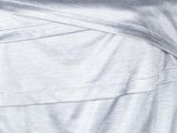 a close up of a woman wearing a silver dress