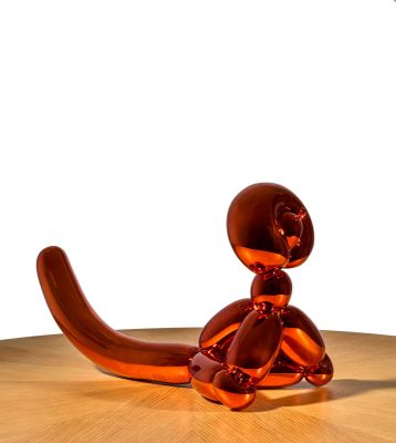 a glass sculpture of a cat sitting on a table