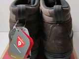 pair of brown vans shoes sitting on top of a box with a price tag