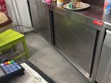 a kitchen with stainless steel counter tops and red cabinets