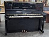 a piano that is sitting in a room next to a table