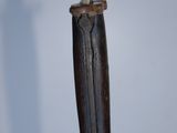 a knife that is hanging from a hook on the wall