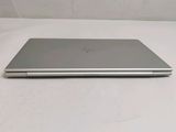 the back of a silver laptop computer sitting on top of a white surface
