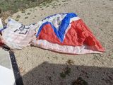 a young boy that is laying on the ground with a parachute