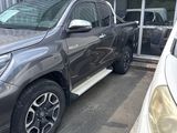 a picture of a grey pick up truck parked in front of a building