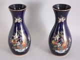 two vases that are sitting on a table