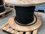 a wooden table that has a black cable on top of it