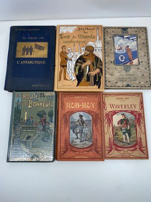 several children ' s books are lined up on a white surface