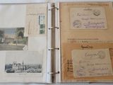 an open book with a bunch of old postcards on it