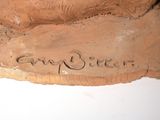 a clay sculpture of a horse with a name on it