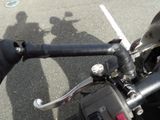a close up of the handlebars of a motorcycle in a parking lot