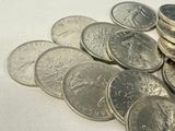 a pile of coins sitting on top of a white table