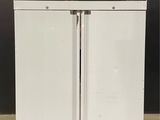 a white refrigerator with two doors open on the floor