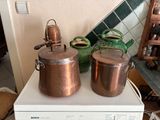 pots and pans sitting on top of a washing machine in a kitchen