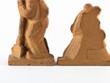 two figurines of a man and a woman sitting on a bench
