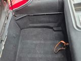 a seat in the trunk of a car with a seat belt