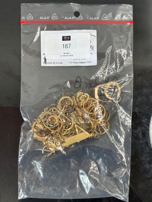 a bag of gold rings on a table next to a toilet
