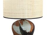 a lamp that is sitting on a table with a lamp shade on it