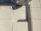 a metal cart that is sitting on a tile floor