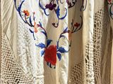 an image of a close up of a shawl with flowers on it
