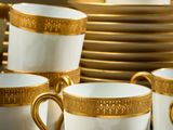 a lot of cups and saucers that are sitting on a table