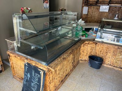 a glass display case with a chalk board sign on it