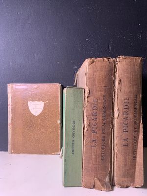 trois livres posés côte à côte sur une étagère