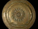 a gold plate with a circular design on it