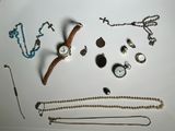 a lot of jewelry on a white surface