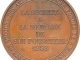 an image of a bronze medal with the name of a school