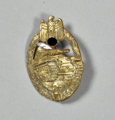 an image of a gold badge with a bird on it