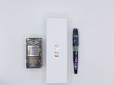 a pen and a box on a white surface