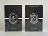 two boxes of perfume sitting on top of a white surface