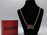 the necklace is next to a red box and a black necklace