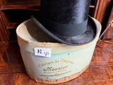 a black top hat sitting on top of a wooden box