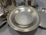 a silver plate with a silver pot and a silver plate with a silver cup