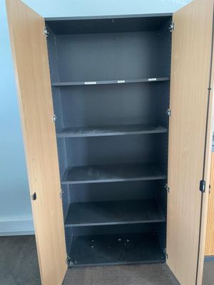 a black cabinet with shelves in the corner of the room