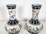 two vases that are sitting on a table