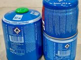 two cans of gas on the counter with labels on them