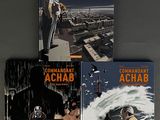 three books on a table with a man on a boat and a man on a boat