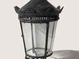 a black lamp with a crown on top of it