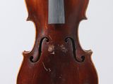 an old violin with a bow hanging from it ' s back