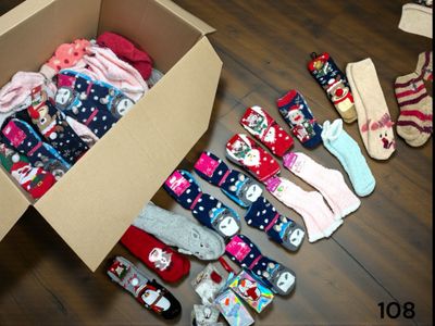 many pairs of socks in a box on the floor