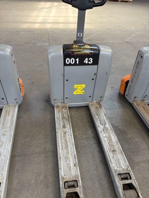 three forklifts that are sitting in a warehouse